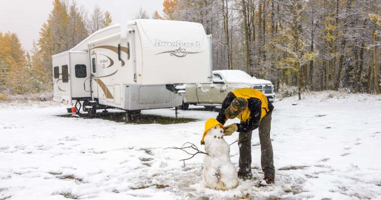 RV in Winters Parked along a Snowman