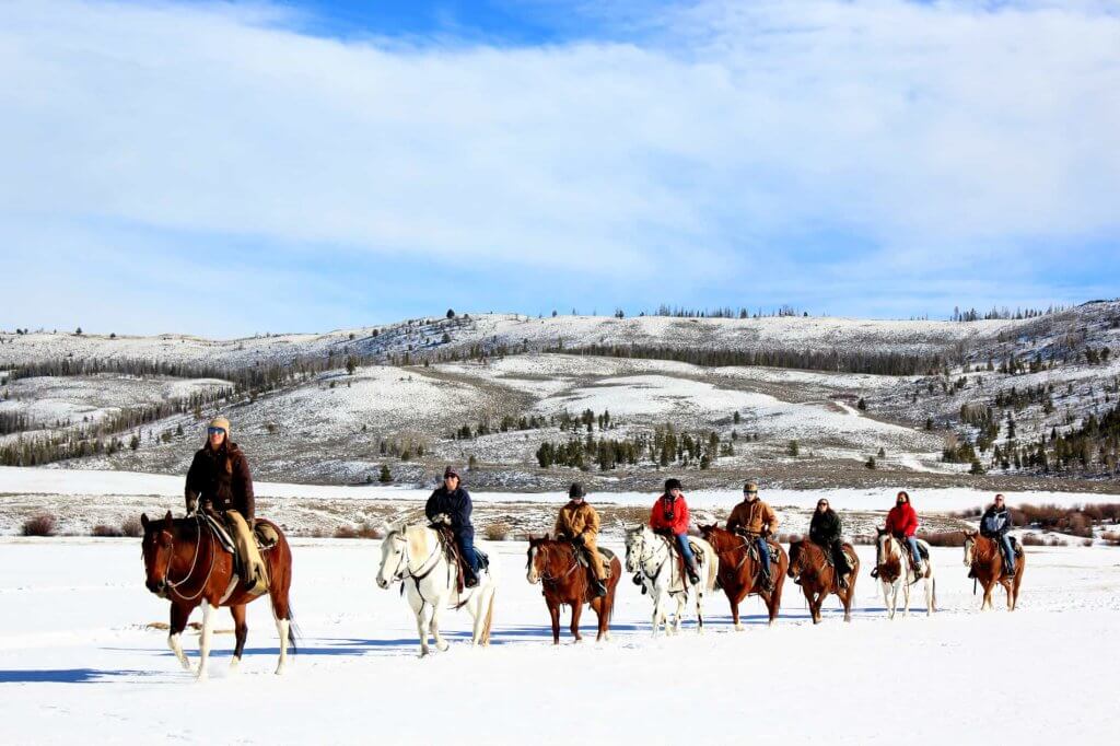 Horseback Riding Through Snow-Covered Trails